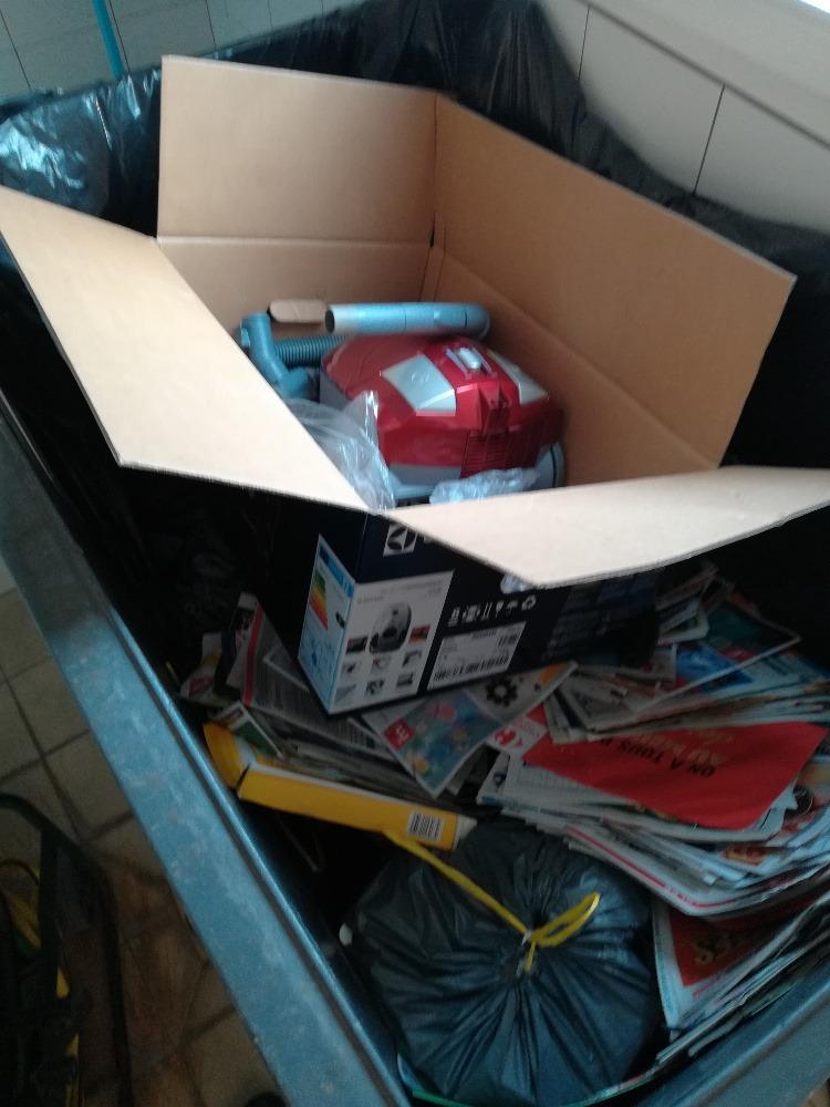 Papiers, cartons et déchets mélangés dans les conteneurs des immeubles.